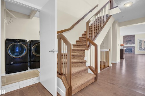Staircase with carpeted treads and wood handrails - 3071 Carpenter Landing Sw, Edmonton, AB 