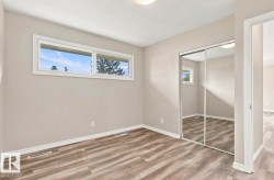 Wood-finish flooring, two large windows, mirrored closet doors, and recessed ceiling lighting - 