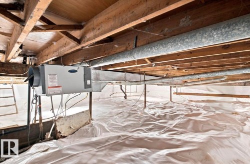Crawl space featuring a dehumidifier unit, metal ductwork, and white vapor barrier - 15812 110A Avenue Nw, Edmonton, AB 