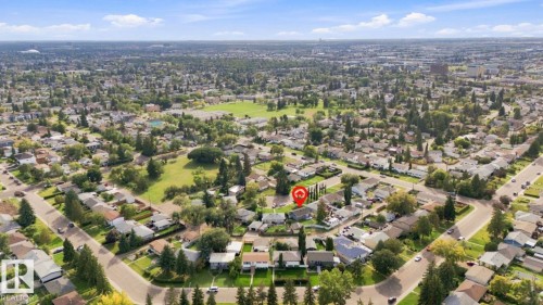 Residential area featuring extensive tree cover, curved streets, and a green space with a circular track - 15812 110A Avenue Nw, Edmonton, AB 