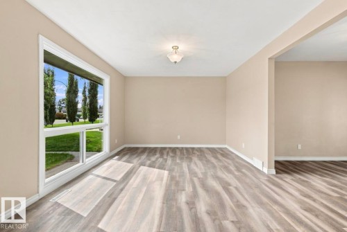 Large picture window, wood-finish flooring, neutral wall tones, recessed ceiling lighting, wide doorway - 15812 110A Avenue Nw, Edmonton, AB 