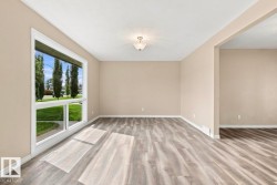 Large picture window, wood-finish flooring, neutral wall tones, recessed ceiling lighting, wide doorway - 
