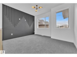 Accent wall with decorative paneling and integrated electrical outlets - 