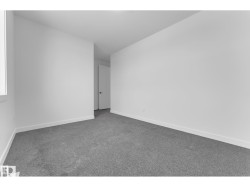 Neutral color palette with white walls, gray carpet flooring, and white trim - 