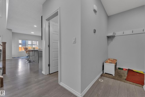 Entryway featuring light wood-finish flooring, light grey wall paint, and white baseboards - 2606 Donaghey Crescent Sw, Edmonton, AB - Indoor Photo Showing Other Room