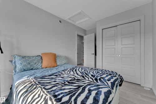 Bedroom featuring light gray walls, light wood-finish flooring, white trim, and a white ceiling - 2606 Donaghey Crescent Sw, Edmonton, AB - Indoor Photo Showing Bedroom