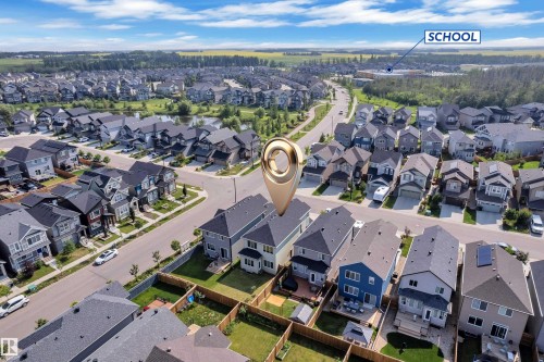 Aerial view of a residential neighborhood featuring detached homes with varied architectural styles, asphalt shingle roofs, and fenced backyards - 2606 Donaghey Crescent Sw, Edmonton, AB - Outdoor With View
