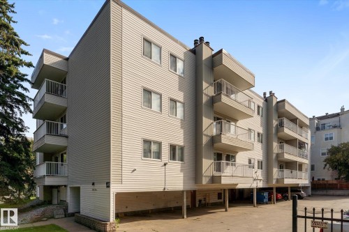 Multi-story building featuring horizontal siding and individual balconies with white railings - #205 8125 110 St Nw, Edmonton, AB 