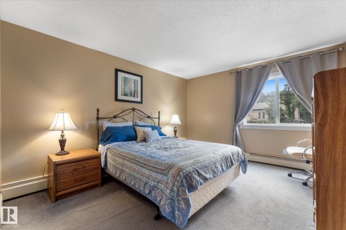 Neutral-toned wall paint with a textured ceiling - #205 8125 110 St Nw, Edmonton, AB 