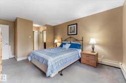 Carpeted flooring, neutral wall paint, white trim, solid core interior doors, and a closet with sliding mirrored doors - 