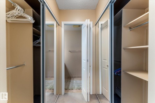 Integrated closet system with shelving and hanging rods - #205 8125 110 St Nw, Edmonton, AB 