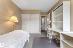 Built-in shelving and desk unit, bi-fold closet doors, and neutral wall tones - 