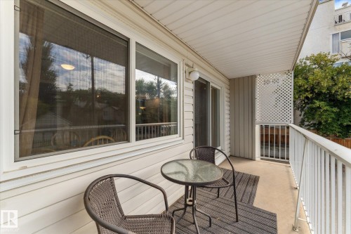 Balcony featuring a concrete floor, white metal railing, and privacy lattice - #205 8125 110 St Nw, Edmonton, AB 
