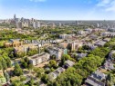 Expansive urban landscape featuring a dense residential area, abundant mature trees, and a distant cityscape - #205 8125 110 St Nw, Edmonton, AB 