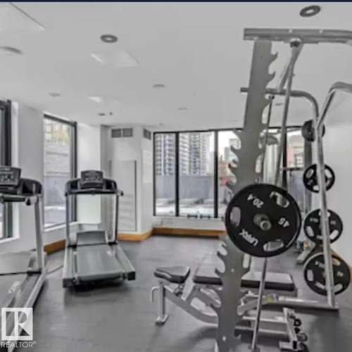 Fitness center featuring large windows, recessed lighting, and rubber flooring - #1006 1010 6 St Sw, Calgary, AB 