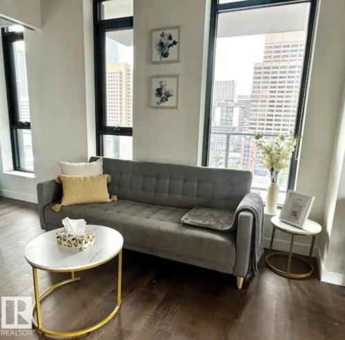 Expansive windows, dark-finish flooring, white wall finishes, and a contemporary wall art installation - #1006 1010 6 St Sw, Calgary, AB 