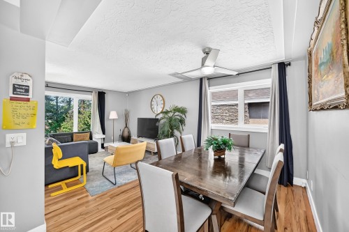 Open concept living and dining area with wood-finish flooring - 10139 74 Street Nw, Edmonton, AB 