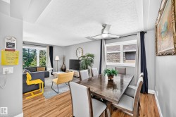Open concept living and dining area with wood-finish flooring - 