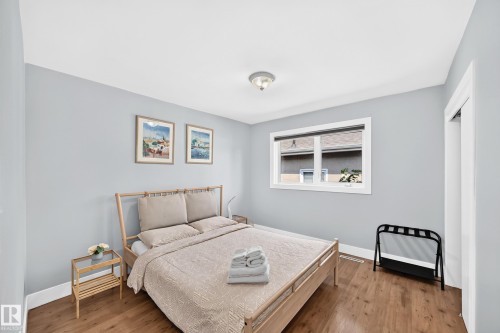 Wood-finish flooring with white trim and a neutral painted ceiling - 10139 74 Street Nw, Edmonton, AB 