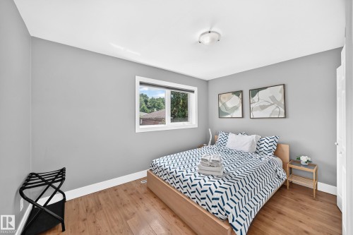 Wood-finish flooring throughout, light gray wall paint, and a white ceiling - 10139 74 Street Nw, Edmonton, AB 