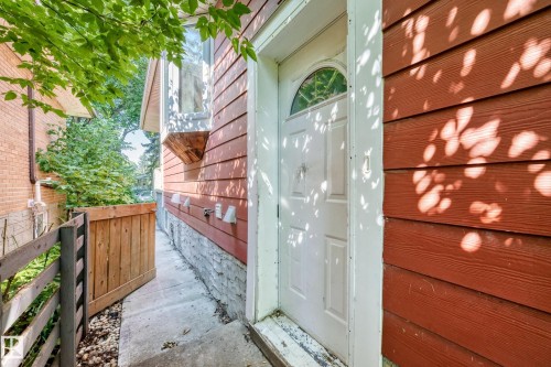 Red horizontal siding with a concrete foundation - 10139 74 Street Nw, Edmonton, AB 