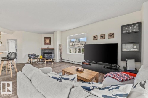 #704 9707 105 St Nw, Edmonton, AB - Indoor Photo Showing Living Room With Fireplace