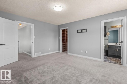 Carpeted flooring with light gray walls and a flush-mount ceiling light - 15420 44 Street Nw, Edmonton, AB 