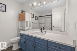 Blue vanity with an integrated sink, polished countertop, and matte black faucet - 