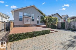 Expansive paver patio with a raised wood-finish deck - 