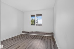 Neutral white walls, wood-finish flooring, and a built-in window bench - 