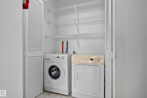 White louvered bi-fold doors, front-loading washing machine, clothes dryer, and wire shelving - #301 9809 110 St Nw, Edmonton, AB 