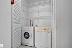 White louvered bi-fold doors, front-loading washing machine, clothes dryer, and wire shelving - 