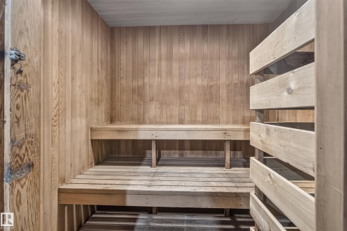 Wood-paneled interior with built-in wooden benches and slatted wooden privacy screen - #301 9809 110 St Nw, Edmonton, AB 