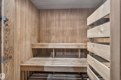Wood-paneled interior with built-in wooden benches and slatted wooden privacy screen - 