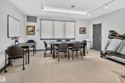 Room with track lighting, multiple windows with roller shades, and light-toned flooring - 