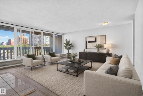 Floor-to-ceiling windows, wood-finish flooring, white walls, and a ceiling-mounted light fixture - #301 9809 110 St Nw, Edmonton, AB 