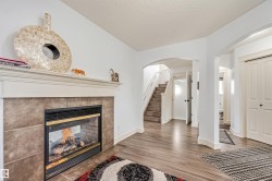 Fireplace with a tile surround and wood mantel - 