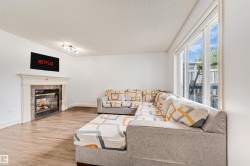 Fireplace with a stone tile surround and white mantel - 