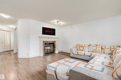 Wood-finish flooring, white walls, and an arched doorway - 