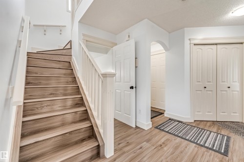 Wood-finish flooring throughout the entryway - 20324 48 Avenue Nw, Edmonton, AB 