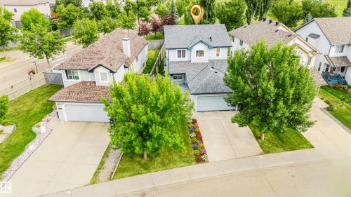 Two-story residence with an attached garage, concrete driveway, and mature landscaping - 20324 48 Avenue Nw, Edmonton, AB 