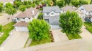 Two-story residence with an attached garage, concrete driveway, and mature landscaping - 20324 48 Avenue Nw, Edmonton, AB 