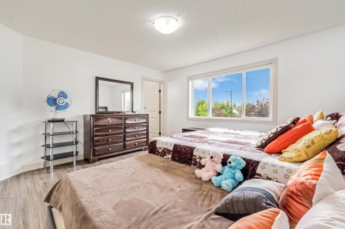 Wood-finish flooring, white walls, and a large window providing natural light - 20324 48 Avenue Nw, Edmonton, AB 