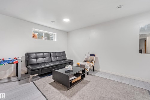 Recessed lighting, wood-finish flooring, and white walls create a bright interior - 20324 48 Avenue Nw, Edmonton, AB 