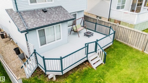 Expansive outdoor deck with perimeter railing and stairs to the yard - 20324 48 Avenue Nw, Edmonton, AB 