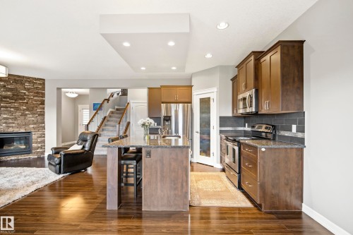 1455 Hays Way Nw, Edmonton, AB - Indoor Photo Showing Kitchen With Fireplace With Stainless Steel Kitchen