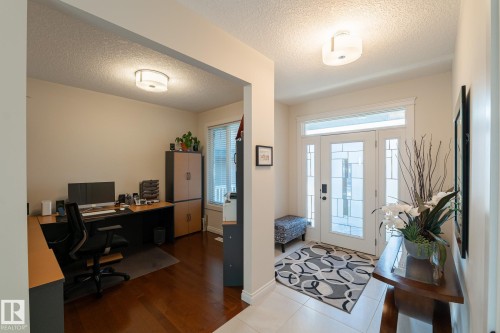 Entryway with white tile flooring and a decorative glass paneled door - 914 Crystallina Nera Way Nw, Edmonton, AB 