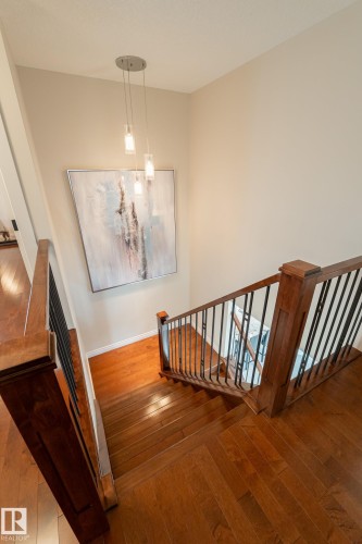 Hardwood flooring, wood newel posts, and wrought iron balusters - 914 Crystallina Nera Way Nw, Edmonton, AB 