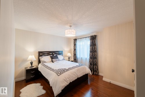 Hardwood-finish flooring, textured white ceiling, drum chandelier, and a window with roller blinds - 914 Crystallina Nera Way Nw, Edmonton, AB 