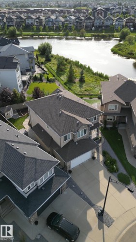 Paved driveway with an attached garage, and a structured roofline - 914 Crystallina Nera Way Nw, Edmonton, AB 